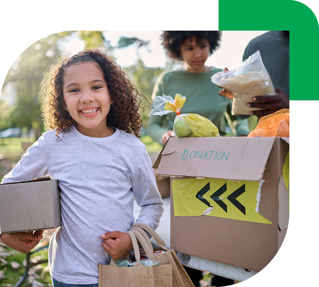 Child helping at a food donation drive.