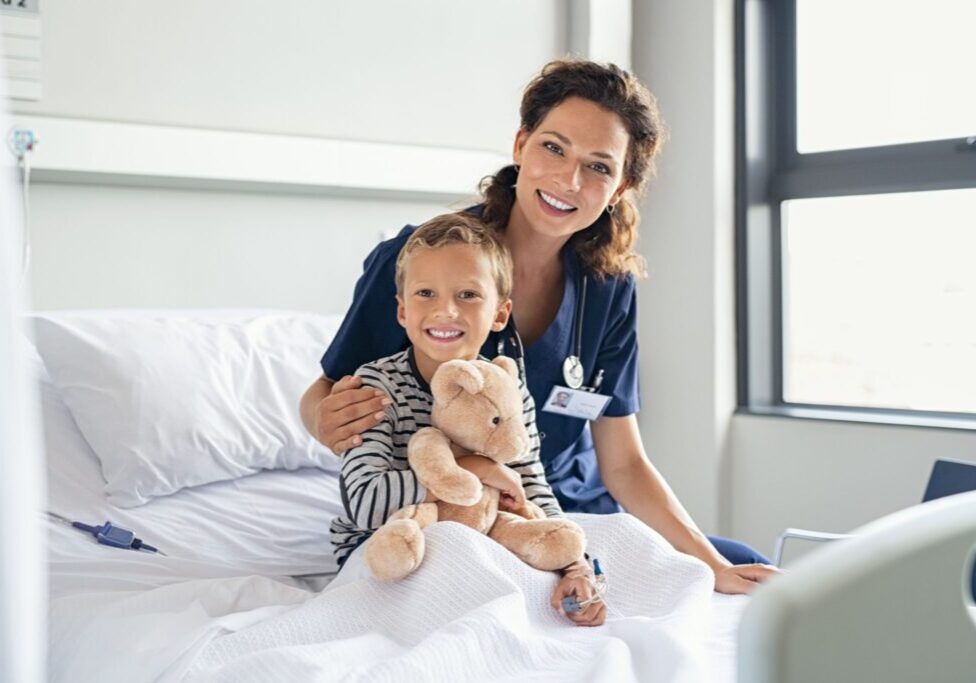 Child with nurse in hospital room.